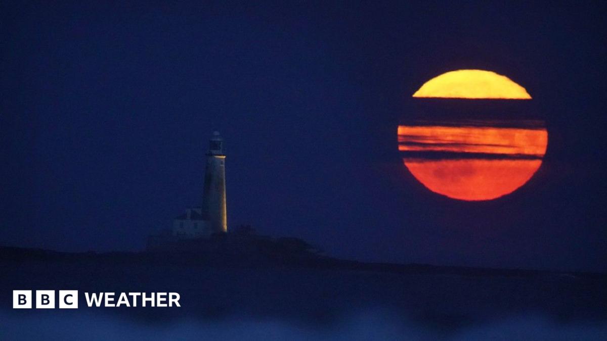 The Full Buck supermoon rises over St Mary's Lighthouse in Whitley Bay on the north east coast of England in July 2023