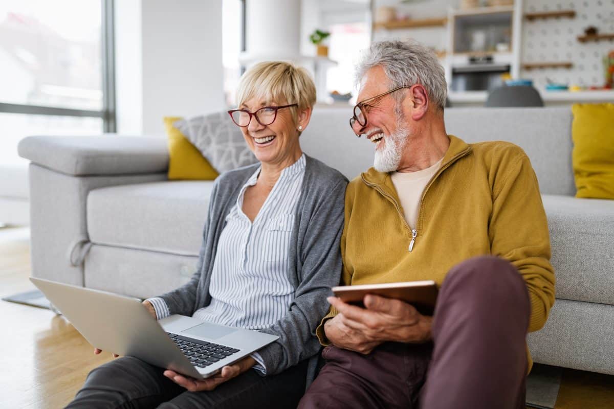 Happy senior couple hugging and enjoying retirement at home