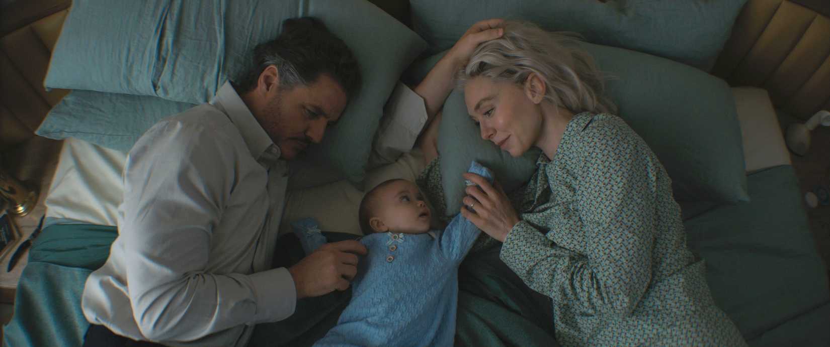 Pedro Pascal as Reed Richards/Mister Fantastic, Ada Scott as Franklin Richards and Vanessa Kirby as Sue Storm/Invisible Woman lay in bed together in Fantastic Four: First Steps