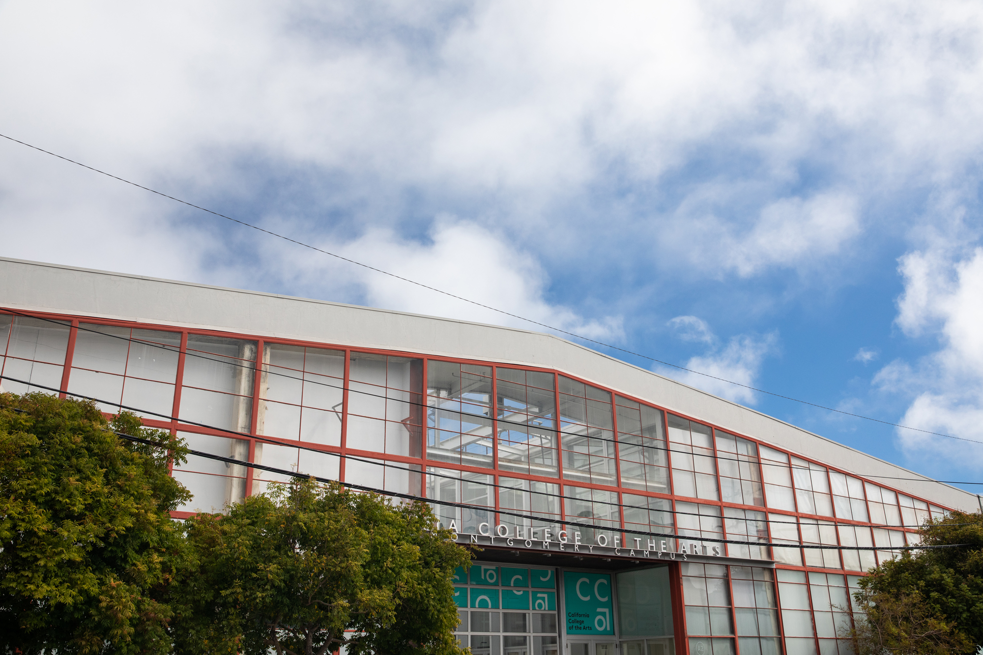 industrial roofline against puffy clouds