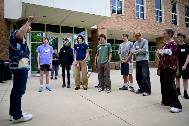 Centaurus High School students listen to a guide during a June 25 tour at the Laboratory for Atmospheric and Space Physics building in Boulder. (Joel Solis/Staff Photographer)