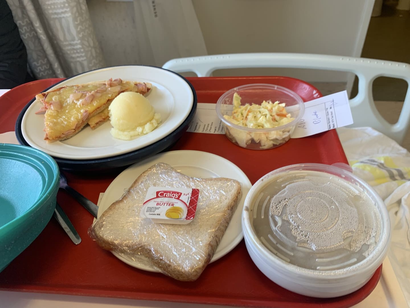 Lunch at Waitākere Hospital: gluten-free pizza with ham, mashed potato, coleslaw, mushroom soup and a slice of bread.