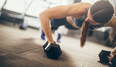 Woman performing a dumbbell push-up during CrossFit style workout