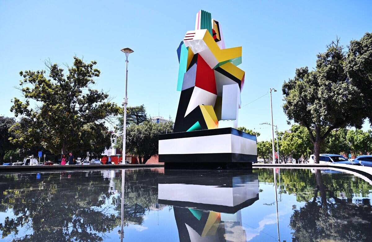 The newly restored statue Dos Amantes, located on the Mariposa Mall near Fresno City Hall, is seen in a reflecting pool after a brief ceremony Tuesday, July 28, 2026 in downtown Fresno.