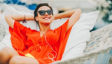 A woman in hammock with headphones on enjoying life which symbolises passive income.