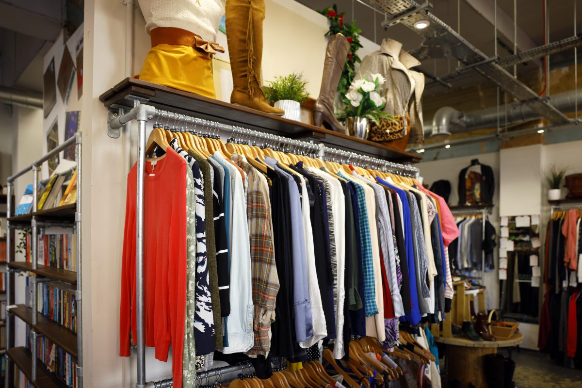 A rail of clothes in a second hand vintage charity shop - stock photo