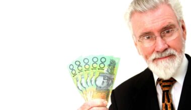 Man holding Australian dollar notes, symbolising dividends.