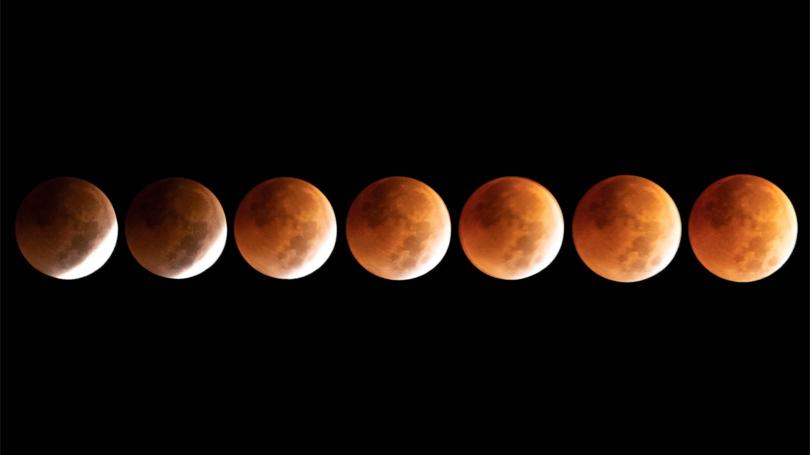 composite image showing a sequence of partial lunar eclipse images with the moon appearing rusty rest with a bright white light illuminating one side.