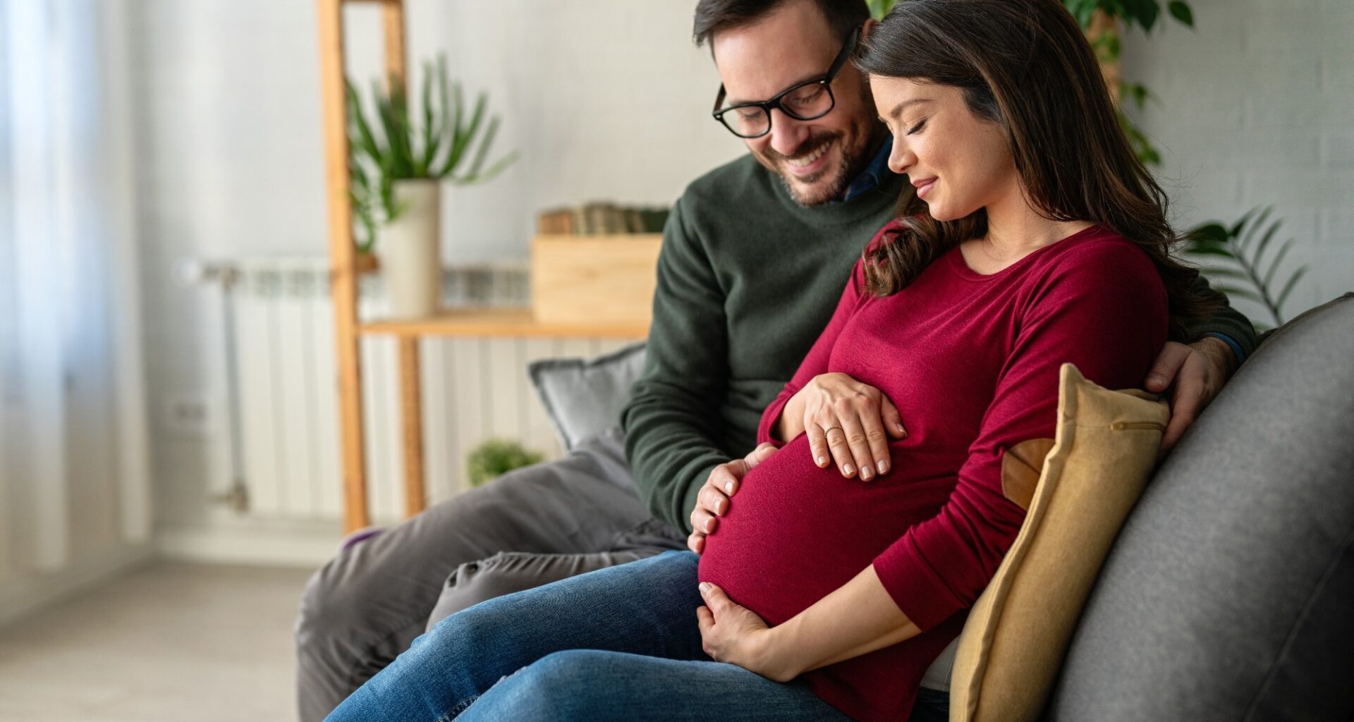 Man in love hugs his pregnant wife, they are waiting together for the baby