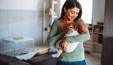 Happy mother holding adorable baby