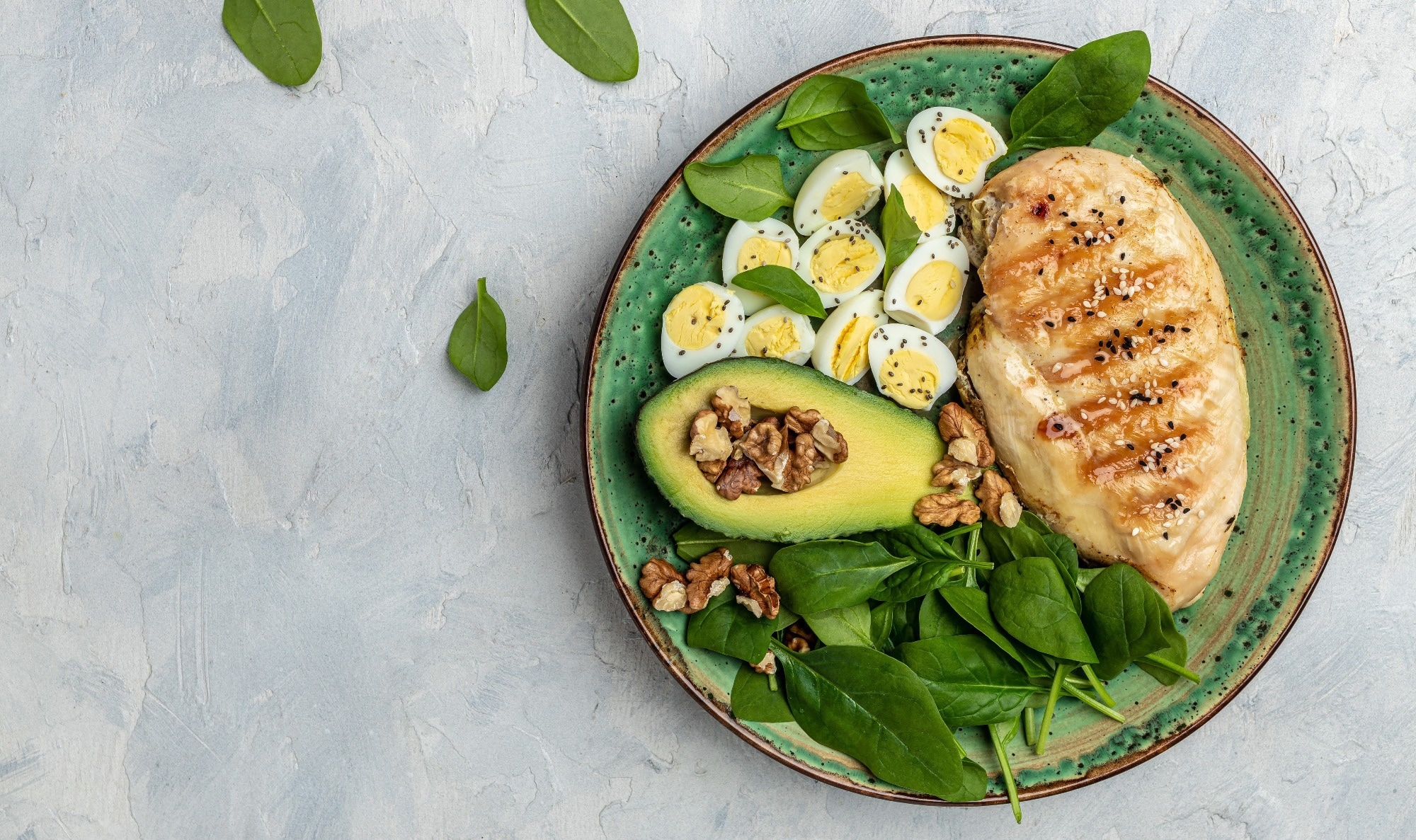 Keto diet: chicken fillet with salad, eggs, avocado and walnuts