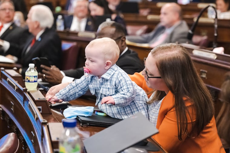 Pennsylvania Representative Jennifer O'Mara (D., Delaware County) with her daughter, Katherine, in the House chambers in Harrisburg in 2023. O'Mara suffered from postpartum depression after giving birth to her daughter. She was unable to do a virtual therapy session with her counselor while out of state. She's helped pass a bill that will change that.