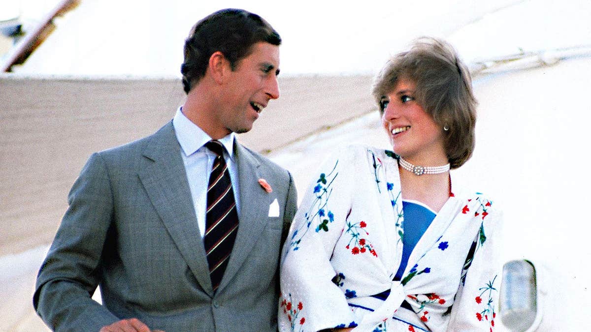 Princess Diana smiling and admiring Prince Charles on a boat.