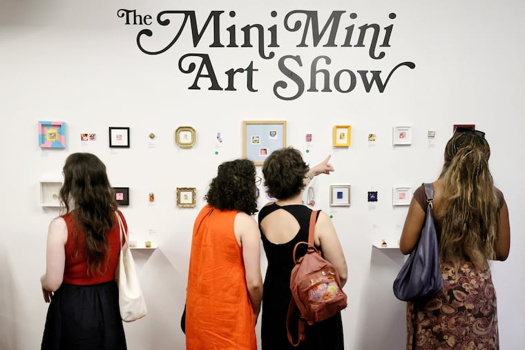 People explore “The Mini Mini Art Show” at At My House on Fourth Street in Philadelphia on July 24, 2026. Every artwork in the exhibition measures 1.5 inches by 1.5 inches — the size of a postage stamp.