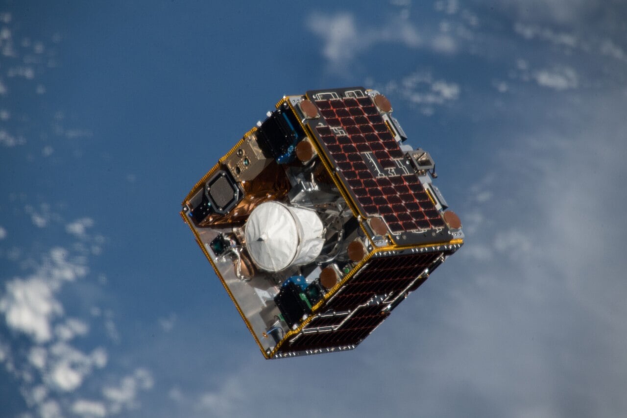 Image of the RemoveDEBRIS debris removal demonstration satellite, which used a net to prove the concept of deorbiting debris with that implement. Credit - NASA/Expedition 56 crew