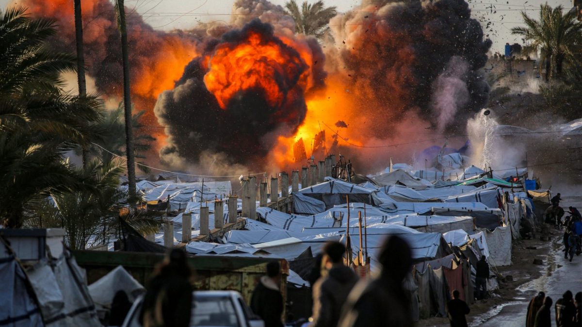 A fireball erupts following an Israeli strike near a tent encampment sheltering people displaced by war in Deir el-Balah in the central Gaza Strip on March 25, 2026. Violence has persisted in Gaza despite a ceasefire which came into effect on October 10, with both Israel and Hamas regularly accusing each other of violations. (Photo by Eyad Baba / AFP via Getty Images)