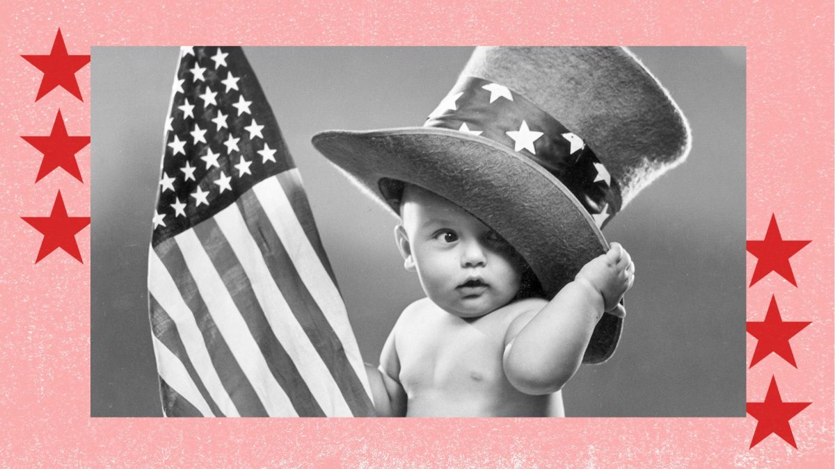 circa 1945: A baby sits on a blanket , wearing an oversize top hat with a band of stars and holding an American flag. (Photo by Lambert/Getty Images)
