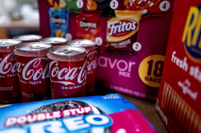 CHICAGO, ILLINOIS - DECEMBER 11: In this photo illustration, food products manufactured by Mondelez and Coca-Cola are shown on December 11, 2024 in Chicago, Illinois. Both companies are among those named in a lawsuit that accuses major food companies of marketing ultra-processed and addictive foods to children. (Photo Illustration by Scott Olson/Getty Images)