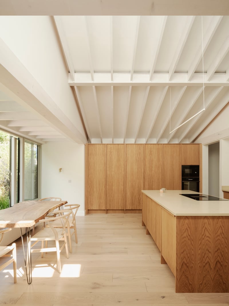 Wide kitchen island doubles as a work space