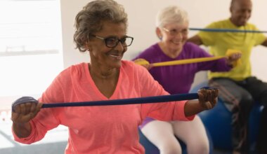 Three older people exercise together using resistance bands and exercise balls.