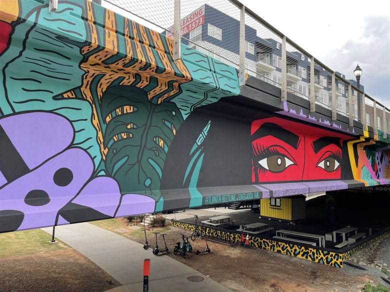 ARRRTaddict's Taíno mural under the Edgewood Avenue bridge, a stop on the Atlanta AR mural tour.