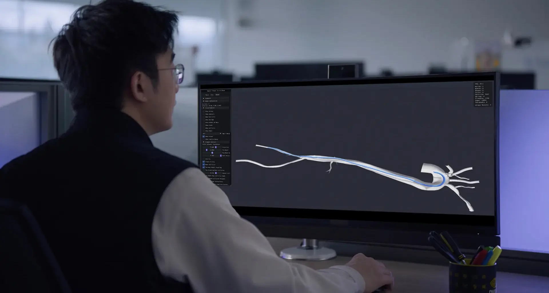 A surgeon using simulation on a computer to place a catheter.