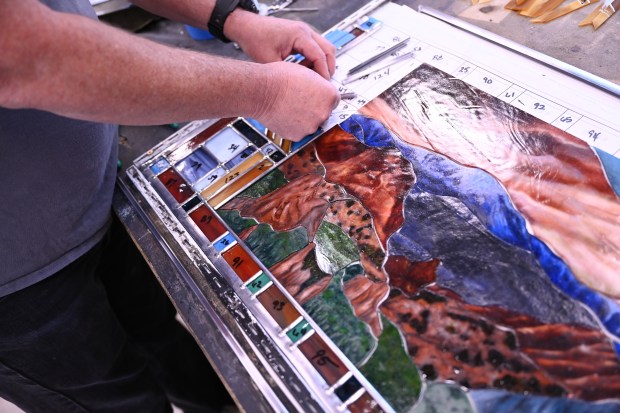 Jim Weishaupl assembles a piece of stained glass at Scottish Stained Glass in Centennial on Tuesday, May 19, 2026. (Photo by Hyoung Chang/The Denver Post)