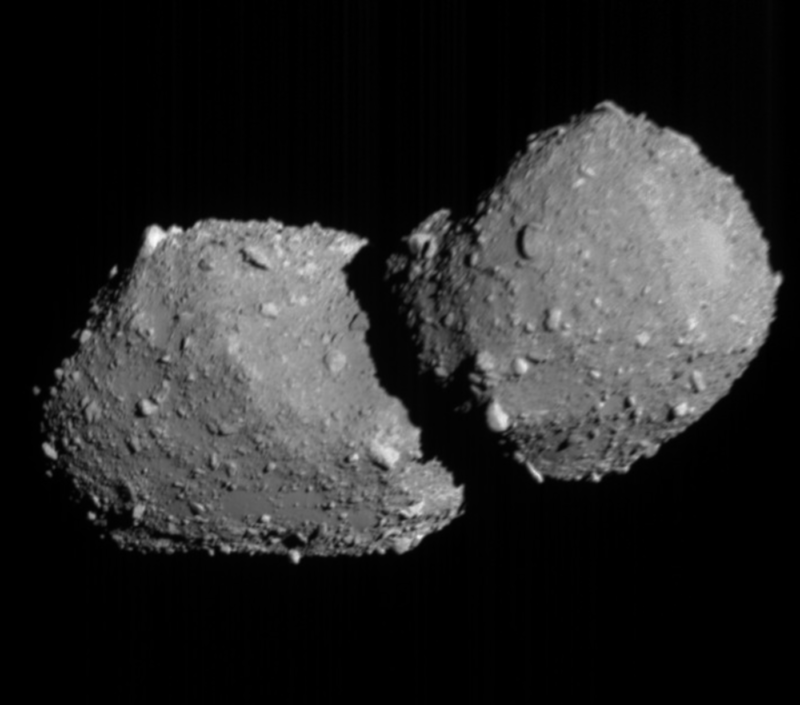 Asteroid flybys: Gray rock object with 2 roundish gray lobes and a narrow waist, totally covered with small bumps.