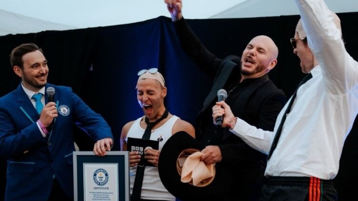 Pitbull breaks Guiness World Record for largest gathering of people wearing bald caps