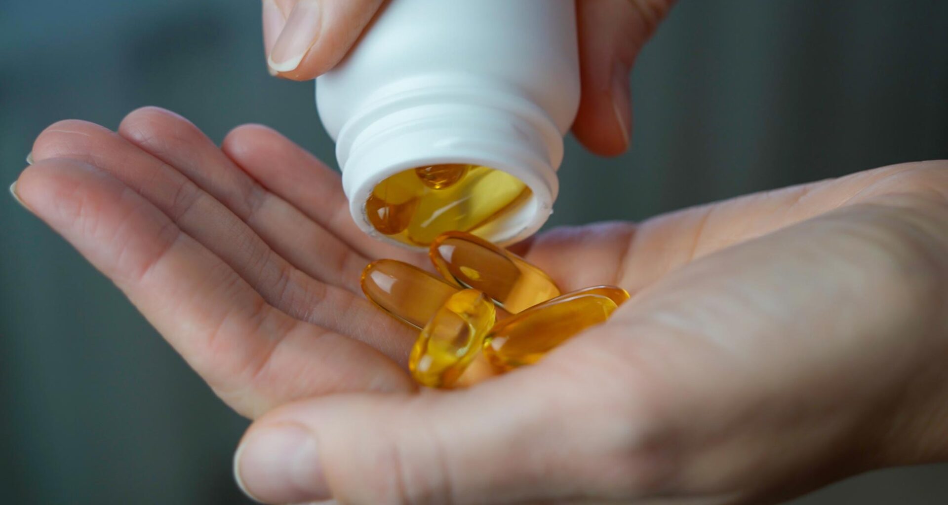 Woman Pouring Vitamin D Omega 3 Vitamin Supplements Hand