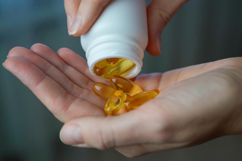 Woman Pouring Vitamin D Omega 3 Vitamin Supplements Hand
