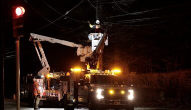 Peco crews work to restore power lines damaged by wind in 2025. The union for these workers recently reached a new contract including cash-balance pensions for all members.