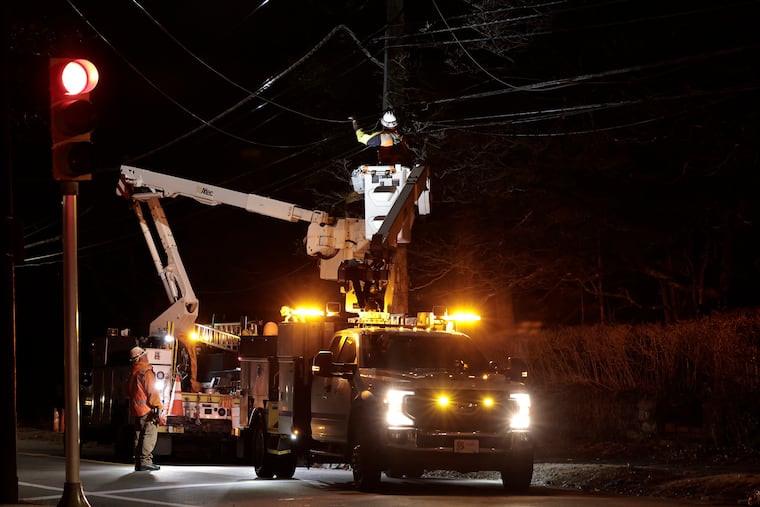 Peco crews work to restore power lines damaged by wind in 2025. The union for these workers recently reached a new contract including cash-balance pensions for all members.