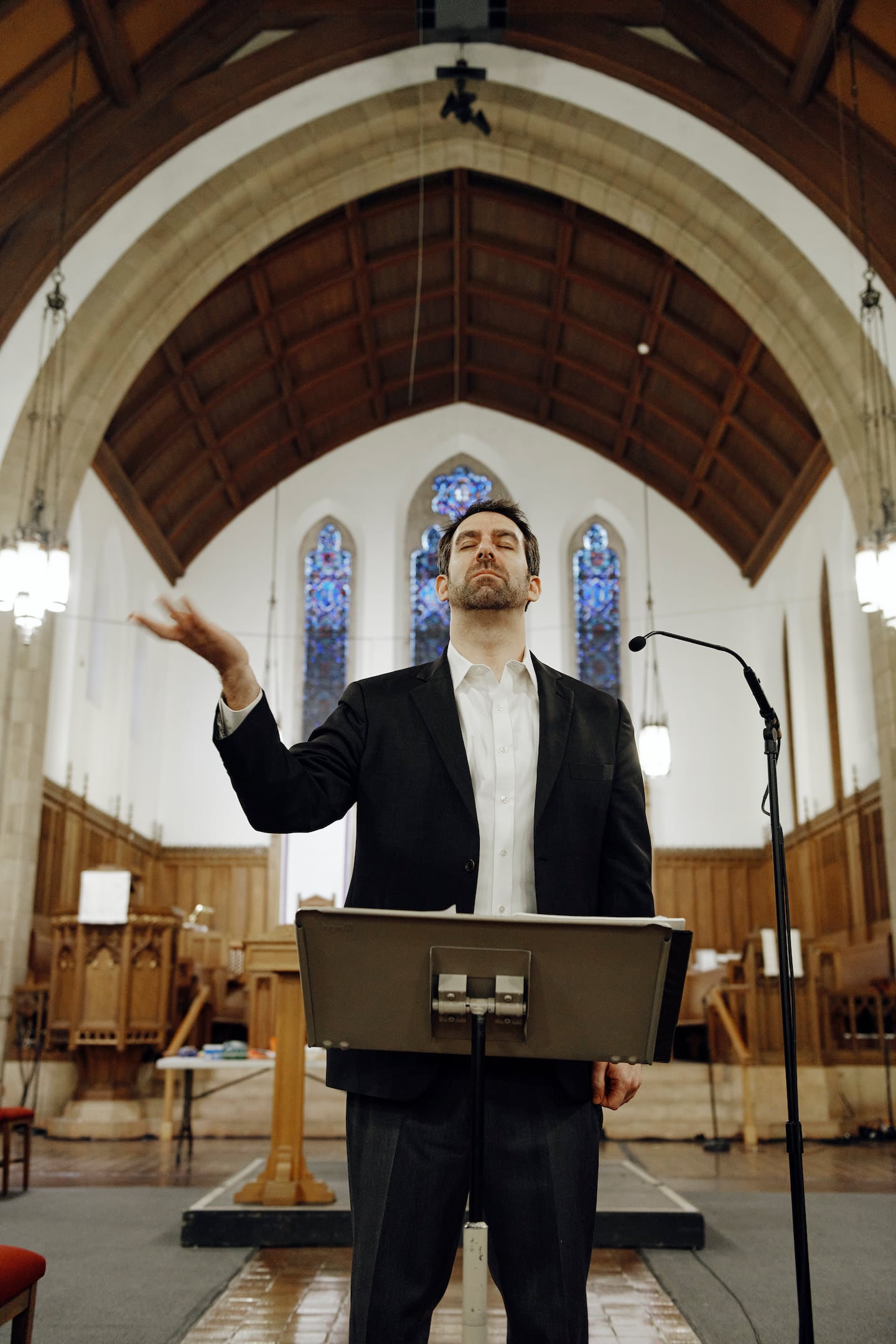 Dr. Jeremy Faust leads a rehearsal of the Longwood Chorus at United Parish in Brookline in April.