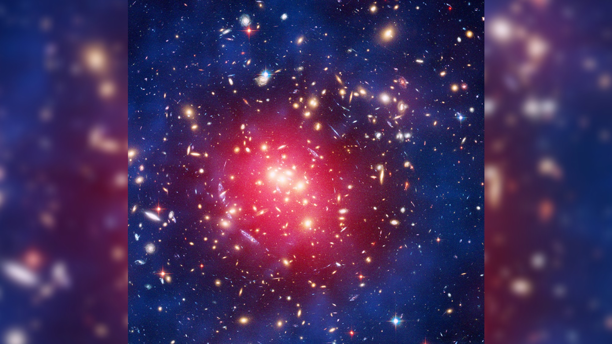 a swirl of blue-and-purple gases amid red pinpoints of light, on a black background