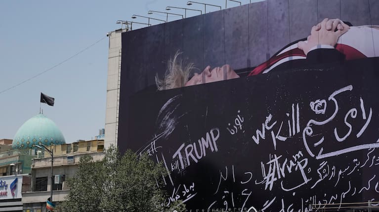 A billboard depicting US President Donald Trump lying on what appears to be a coffin .