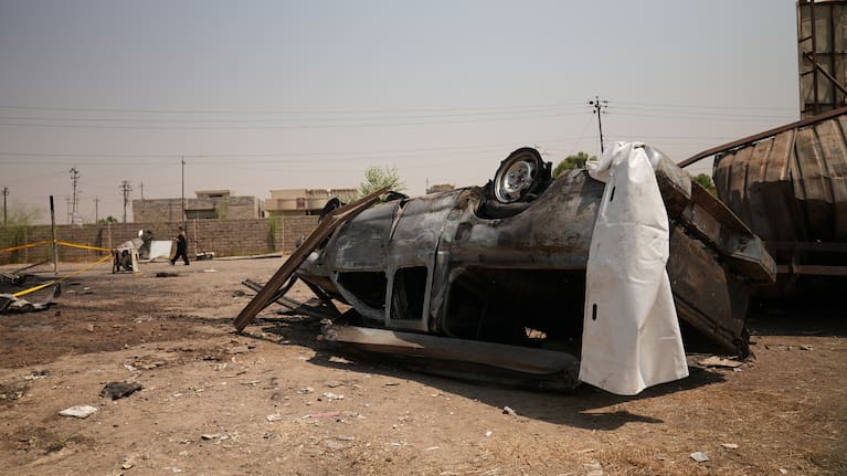 A damaged vehicle at the site of an airstrike on a Popular Mobilization Forces base in Mosul, Iraq.
