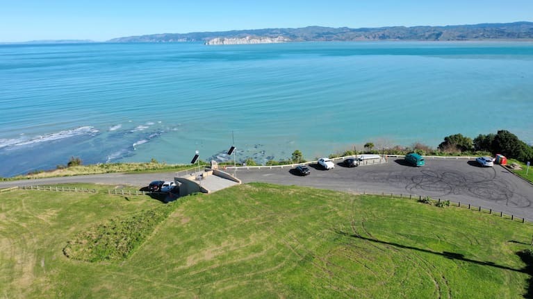 A drone shot shows tyre marks from burnouts and damage to the grass area at the Titirangi Maunga/Kaiti Hill lookout.