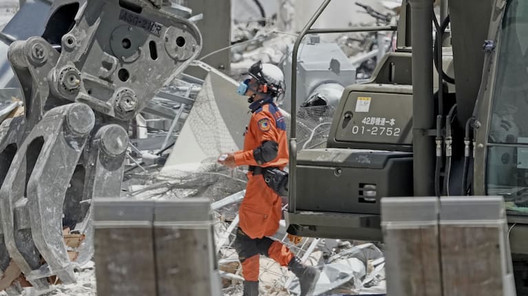 A firefighter searches the damaged AEON Mall following an explosion triggered by an earthquake in Kashima, Kumamoto Prefecture, southern Japan, Friday, July 31, 2026. 