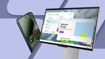 A Google Pixel phone standing next to an external monitor displaying a desktop mode interface.