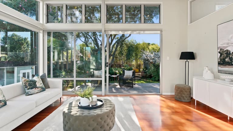 A spacious living room with large windows to take in the wildlife. (Source: Realestate.co.nz)