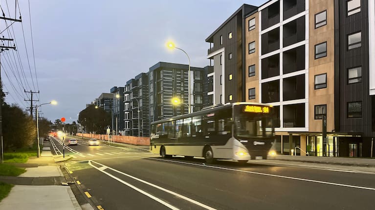 A standard bus in Auckland next to apartments under construction in Northcote (file image).