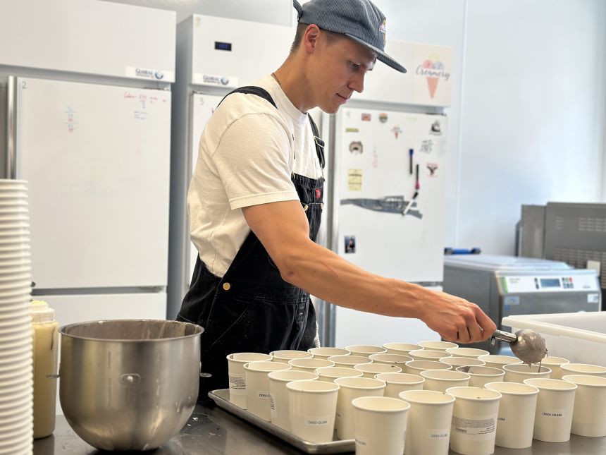 Zach Vraa, owner of A to Z Creamery in Hopkins, Minnesota, scoops freshly made Oreo ice cream into pints on July 23, 2026.