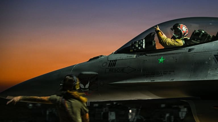 A US F-16 carries out pre-flight checks.