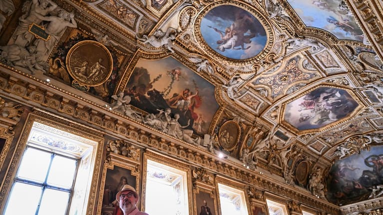A visitor looks on during the reopening to the public of the Apollo Gallery, at the Louvre museum in Paris, Wednesday, July 22, 2026. (Source: Lou Benoist/Pool Photo via AP)