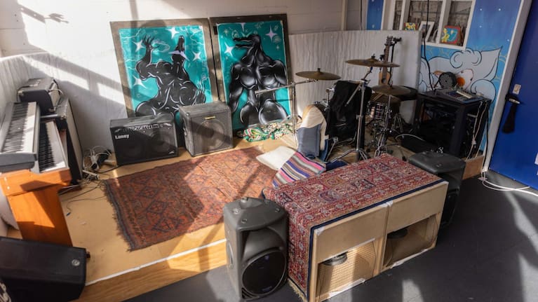 A wooden stage stands at one end of the Wellington flat's living room.