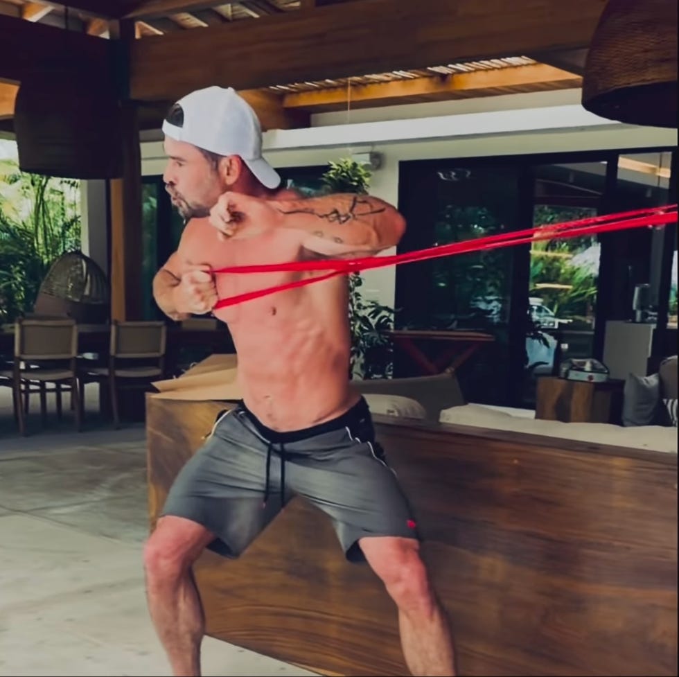 person doing resistance band workout indoors. person doing resistance band workout indoors.