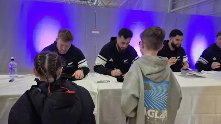 All Blacks fans line up in Christchurch to get things signed by the players.