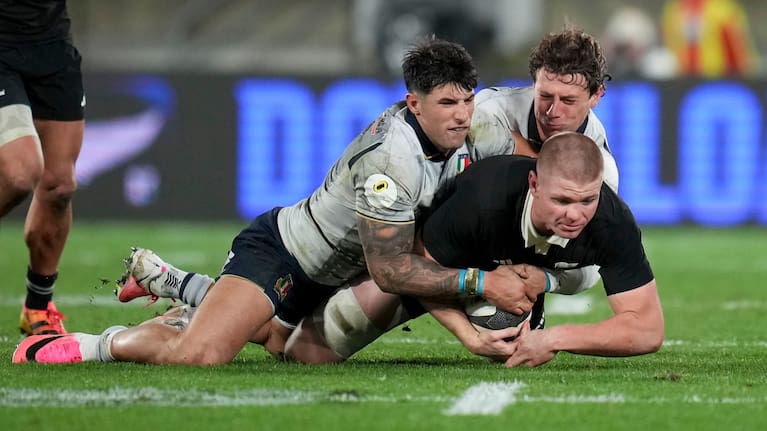 All Blacks flanker Anton Segner is tackled during his team's win over Italy in Wellington.