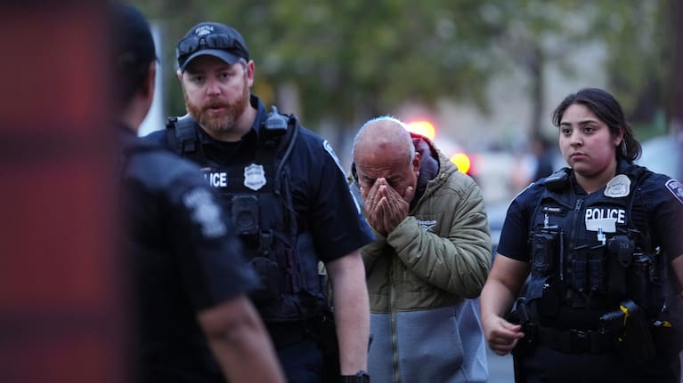 An unidentified man is led into the scene by police after they responded to a shooting at Seattle Center during the Bite of Seattle food festival.
